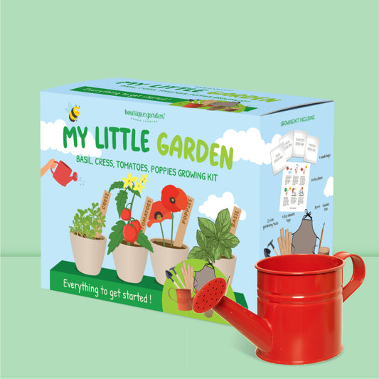 Boîte du kit de jardinage pour enfant 'My Little Garden' à côté d'un petit arrosoir rouge.